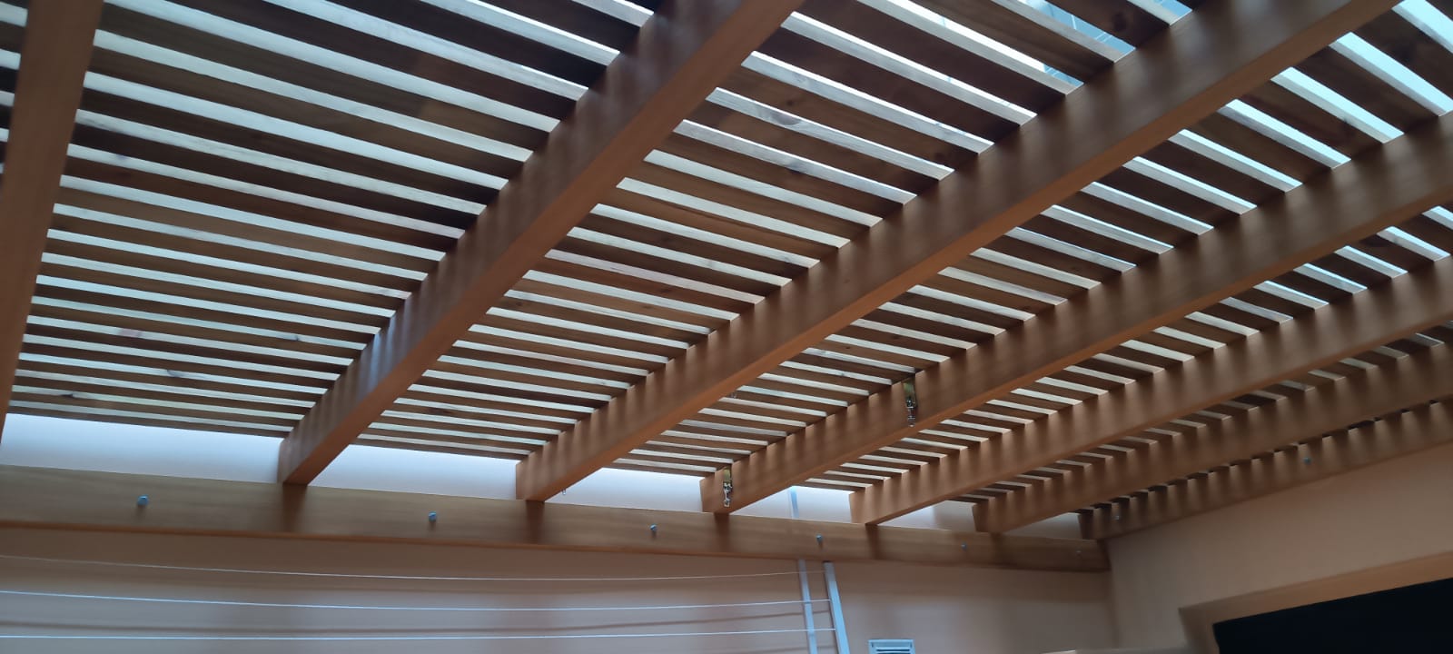 Cielorraso de listones de madera con vigas, vista interior
